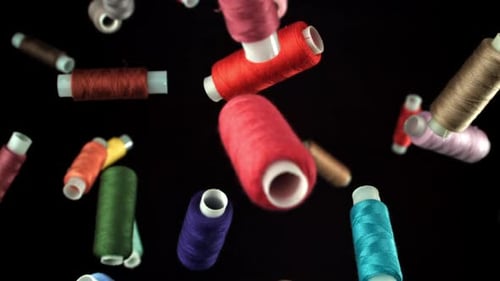 Multicolored Threads Fly on a Black Background Filmed on a Highspeed Camera at 1000 Fps