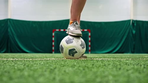 close-up of a soccer player's foot kicking the ball for a penalty or a goal or passing a ball