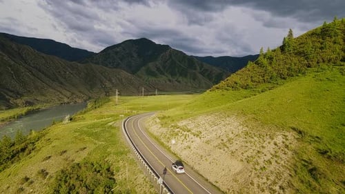 Car is Driving on the Road with a View of the Mountains
