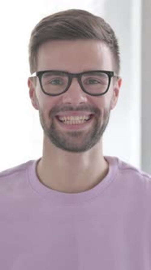 Smiling Young Adult Man in Glasses Portrait Close-Up