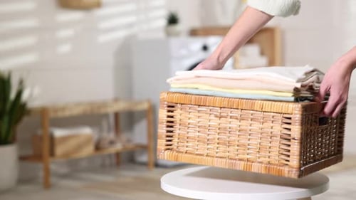 Laundry Room Basket with Clothes Being Folded