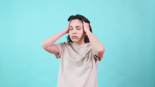 Woman Massaging Temples in Studio Suffering Headache