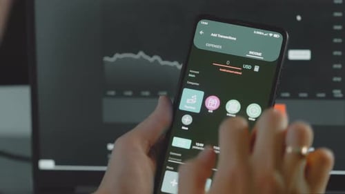 Close Up Of Person Using Income Tracking Application