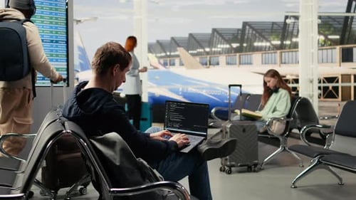 Digital Nomad Man Programming on Laptop in International Airport