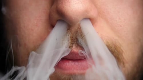 Smoke Breathes From Man's Nostrils in Close Up Smoke Breathes From Man's Nostrils in Close Up