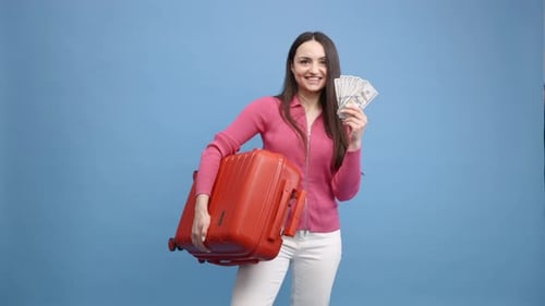 Woman Holding Money and Suitcase, Smiling