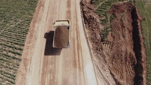 Truck Carrying Soil on a Dirt Road Aerial Shot