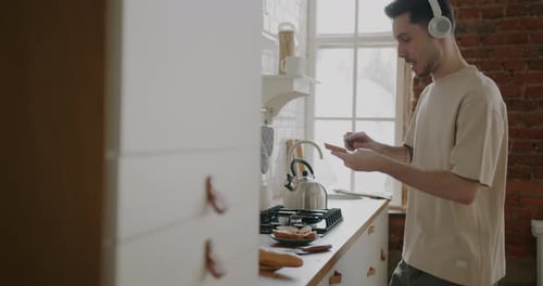 Young Man Preparing Food in Kitchen at Home