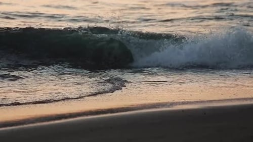 The beautiful waves rolling to the beach of Bali, Indonesia - slow motion