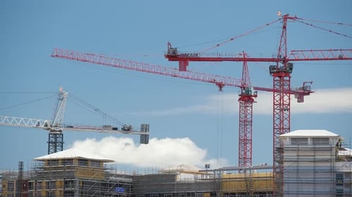 Tower Lifting Cranes at High Residential Apartment Building Construction Site Real Estate