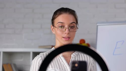 School Math Female Teacher Having Online Class Using Smartphone with Tripod