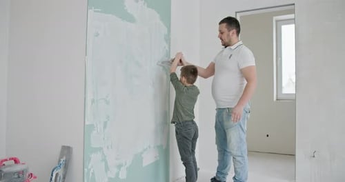 Man and Child Plaster Wall Together