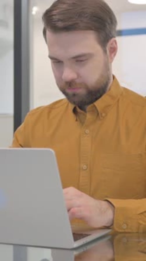Man Video Calling on Laptop in Office