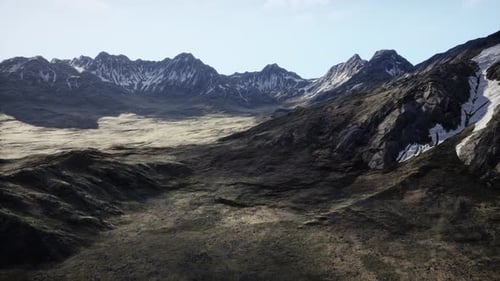 An Aerial View of a Mountain Range with Snow on the Mountains