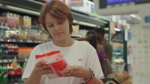 Young Woman Choosing Sugar in the Supermarket Close Up