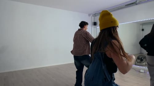 Young dancers performing energetic choreography in dance studio