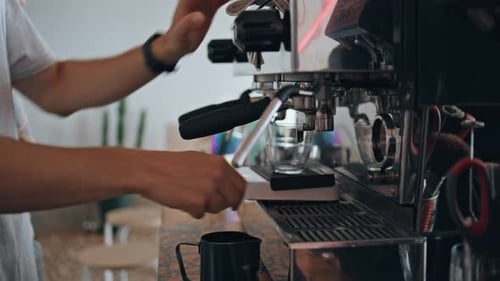 Barista Hands Making Coffee with Modern Coffee Machine in Cafeteria Close Up