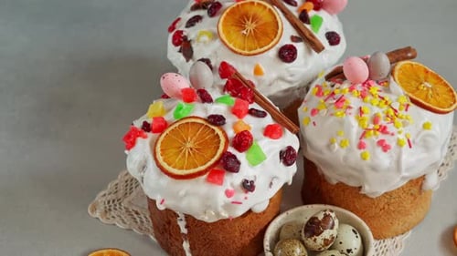 Close up of Traditional Easter Cakes decoreted with dried Fruits on Grey Background. Copy space
