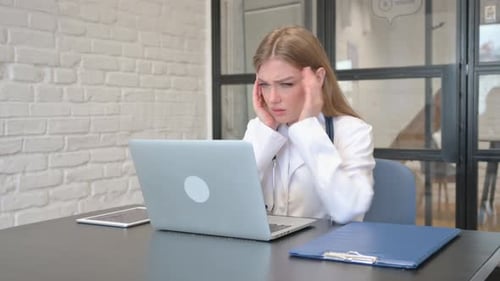 Working Female Doctor having Headache in Hospital