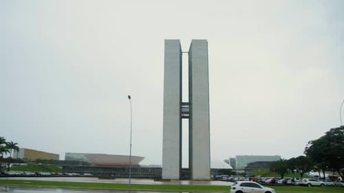 Outside view of Brazilian Congress Building in Brasilia in a Rainy Cloudy Day with green grass Pan S
