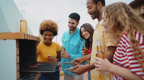 Multiethnic group of friends having dinner barbecue party
