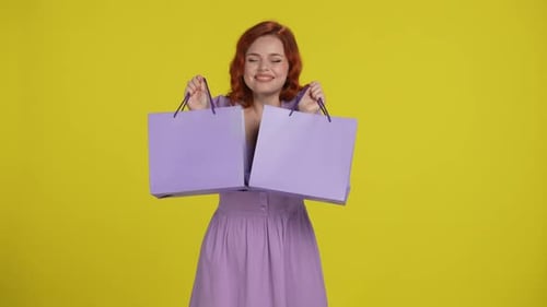 Happy Young Woman Holding Shopping Bags