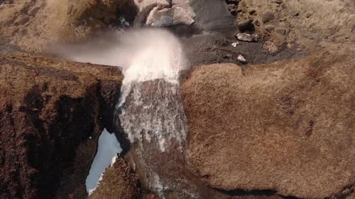 Drone aerial of a waterfall in southern Iceland. Stationary shot overhead