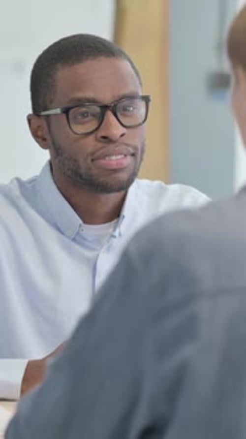 African Businessman Talking with Woman in Office, vertical video