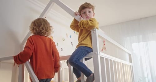Two Children Playing on Bunk Bed in Bedroom