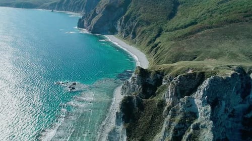 Aerial Panoramic View of the Rocky Cliffs Seaside and Waves are Crashing to the Coast Beautiful