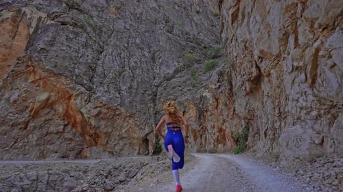 Female Athlete Running in Canyon