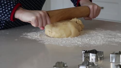 Rolling Cookie Dough on Kitchen Counter with Cutters