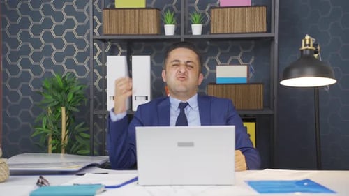 Angry Businessman Gesturing at Laptop During Video Conference