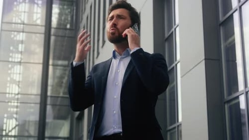Furious Business Man Arguing on Cell Phone Outdoors