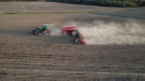 Agricultural tractor with special trailed equipment works the land before sowing crops,