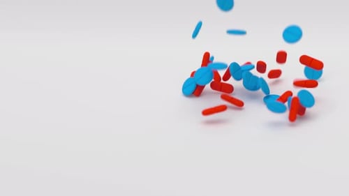 Blue and Red Tablets Falling on White Background in Slow Motion Drugs Pills Tablets Medicine Concept