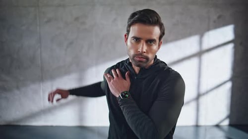 Serious Sportsman Warming Shoulder at Studio Portrait Fitness Guy Exercises