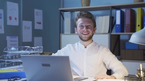 Young Adult at Work Desk Smiling