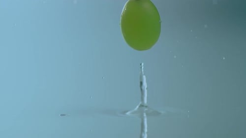 Green Grape Falling into Water in Slow Motion