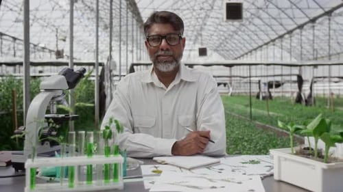 Portrait of Senior Plant Scientist in Greenhouse Laboratory