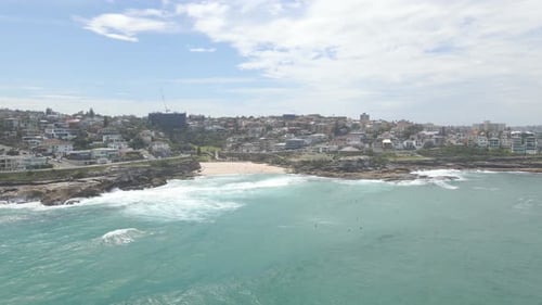 People Swimming With Ocean Waves Surging Towards The Shore. Tamarama Beach In Eastern Suburbs Of Syd