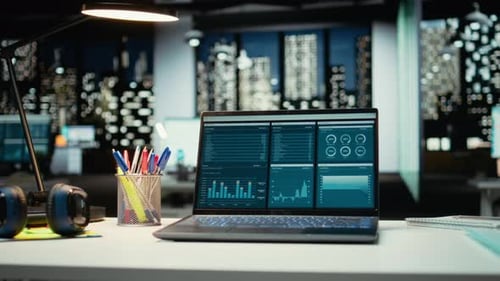 Laptop with Financial Data on Desk at Night
