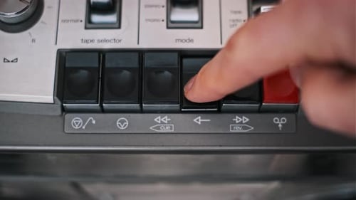 Pressing Play Button on Vintage Tape Deck