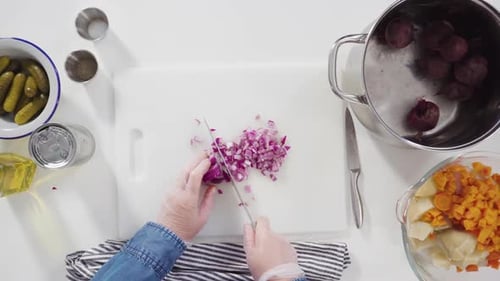 Flat Lay Step By Step Cutting Cookies Vegetables on a White Cutting Board for Vinaigrette Salad