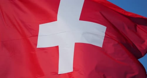 Flag Waving in the Wind Against Blue Sky