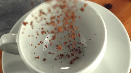 Granules Falling into Coffee Cup