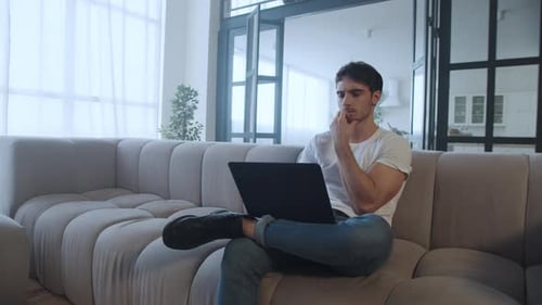 Serious Businessman Using Laptop At Home Office In Slow Motion. Focused Man Working Computer At R...