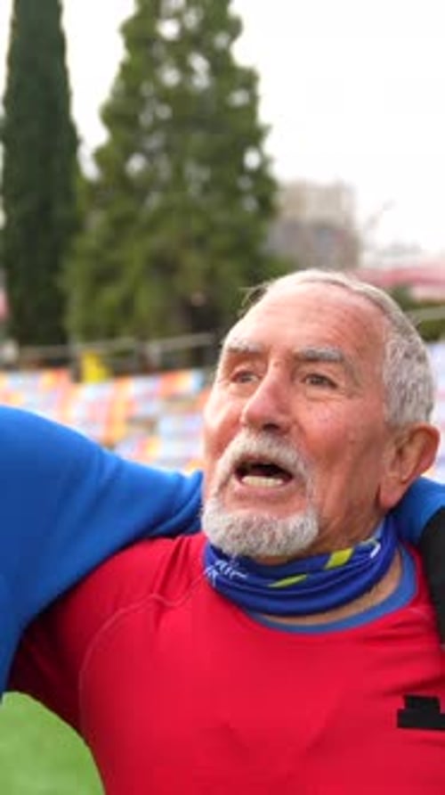 Elder Men Warming Up in an Athletics Field Together