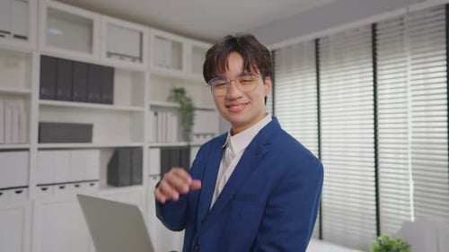 Portrait of Asian young businessman working in the office workplace.