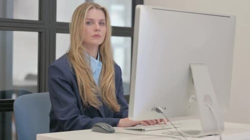 Woman Working At Her Computer In Office